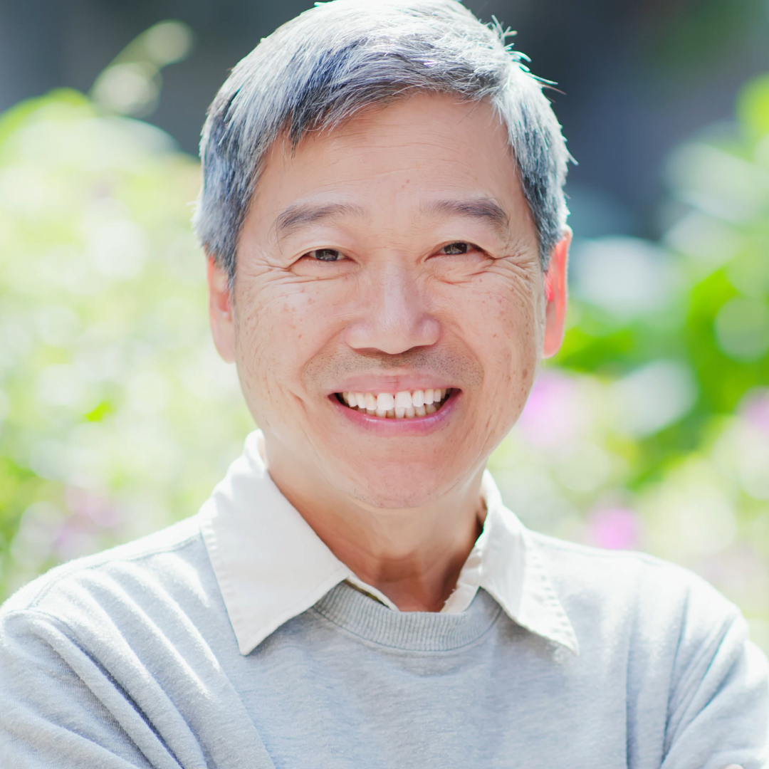 Asian man smiling.